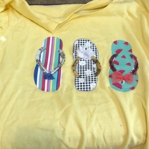 It’s a yellow flip flop shirt for kids.